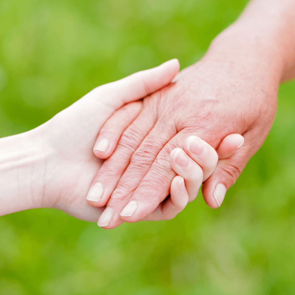 Two hands reaching for each other against a green background